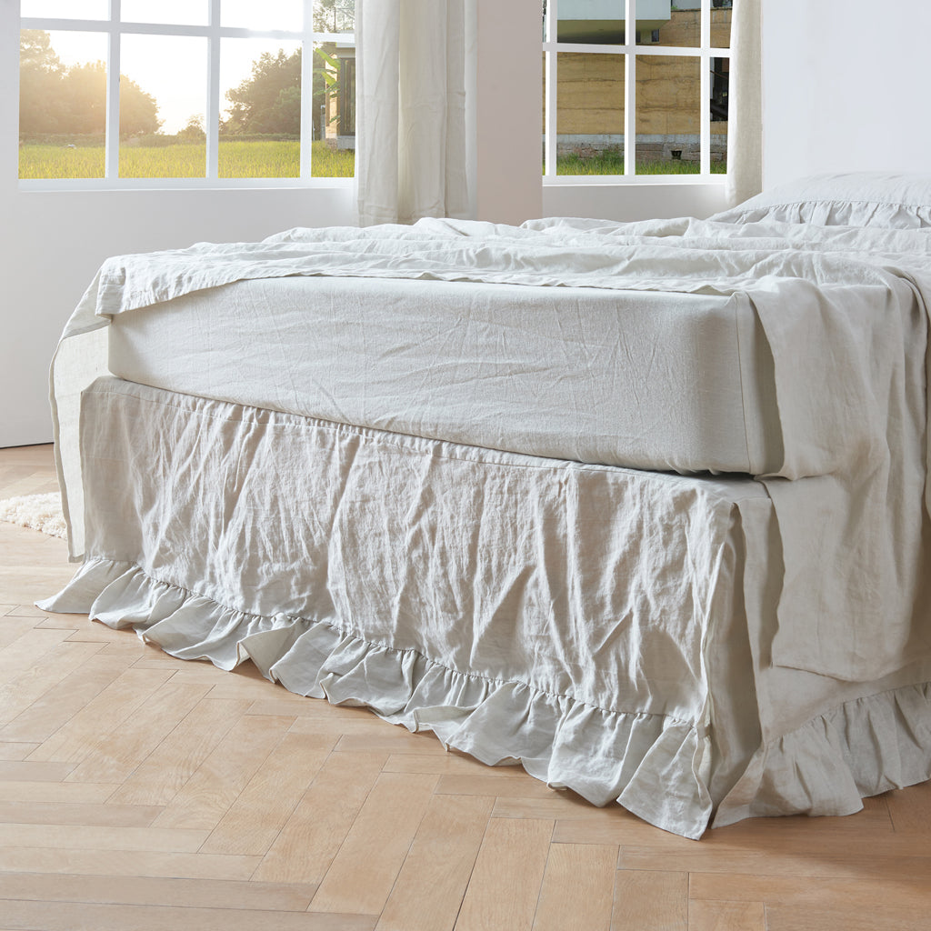Linen bedskirt on bed