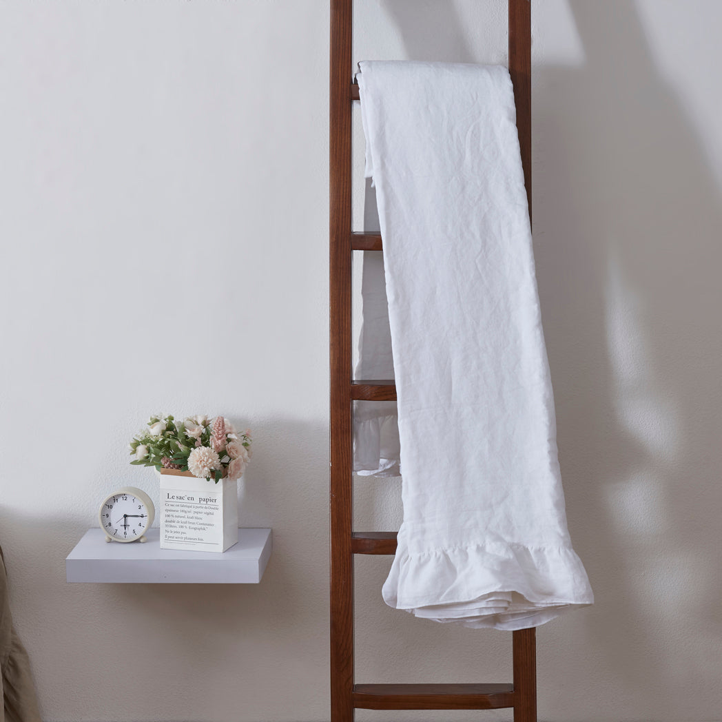 Folded White Linen Ruffle Hem Coverlet