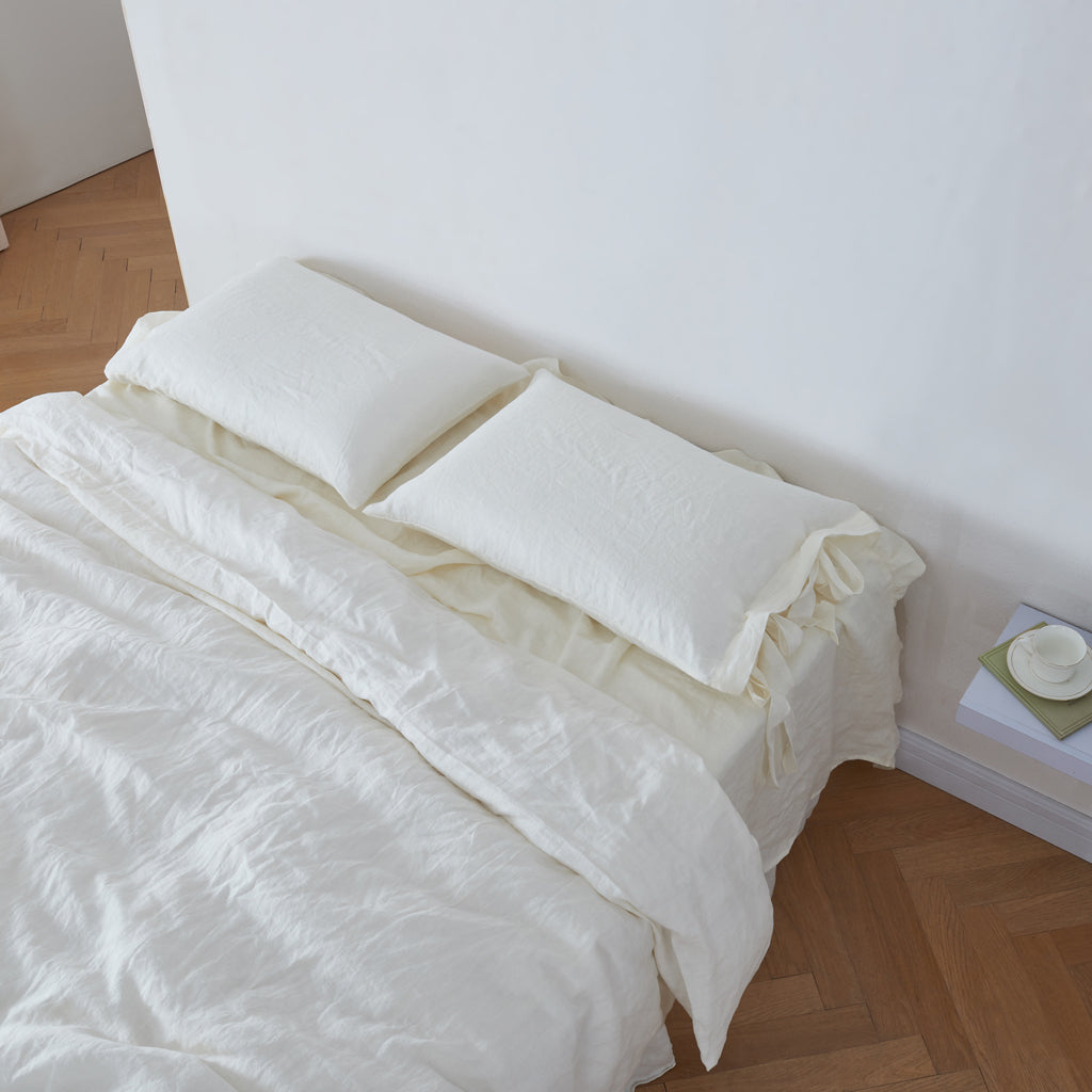 Ivory Linen Pillowcases with Bow Ties on Bed