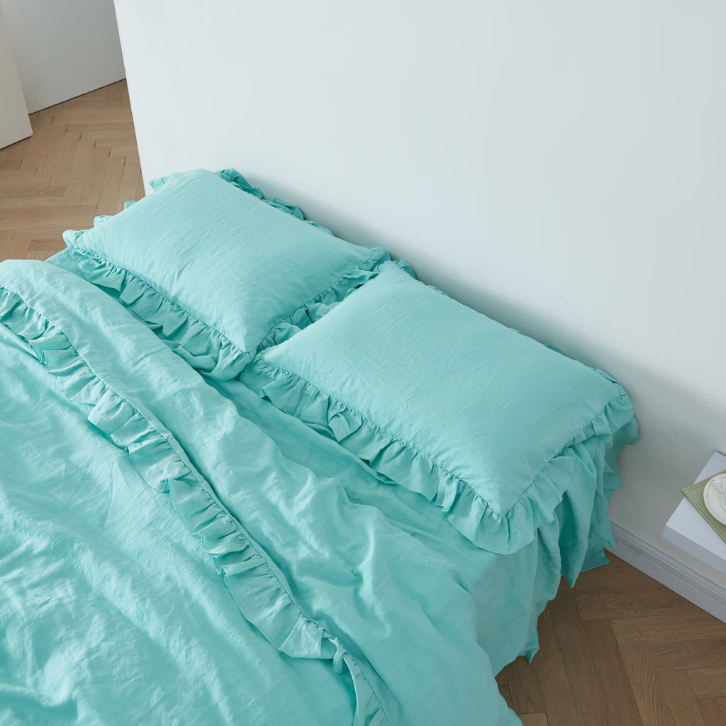 Aqua Green Linen Pillowcases with Ruffle Hem on Bed