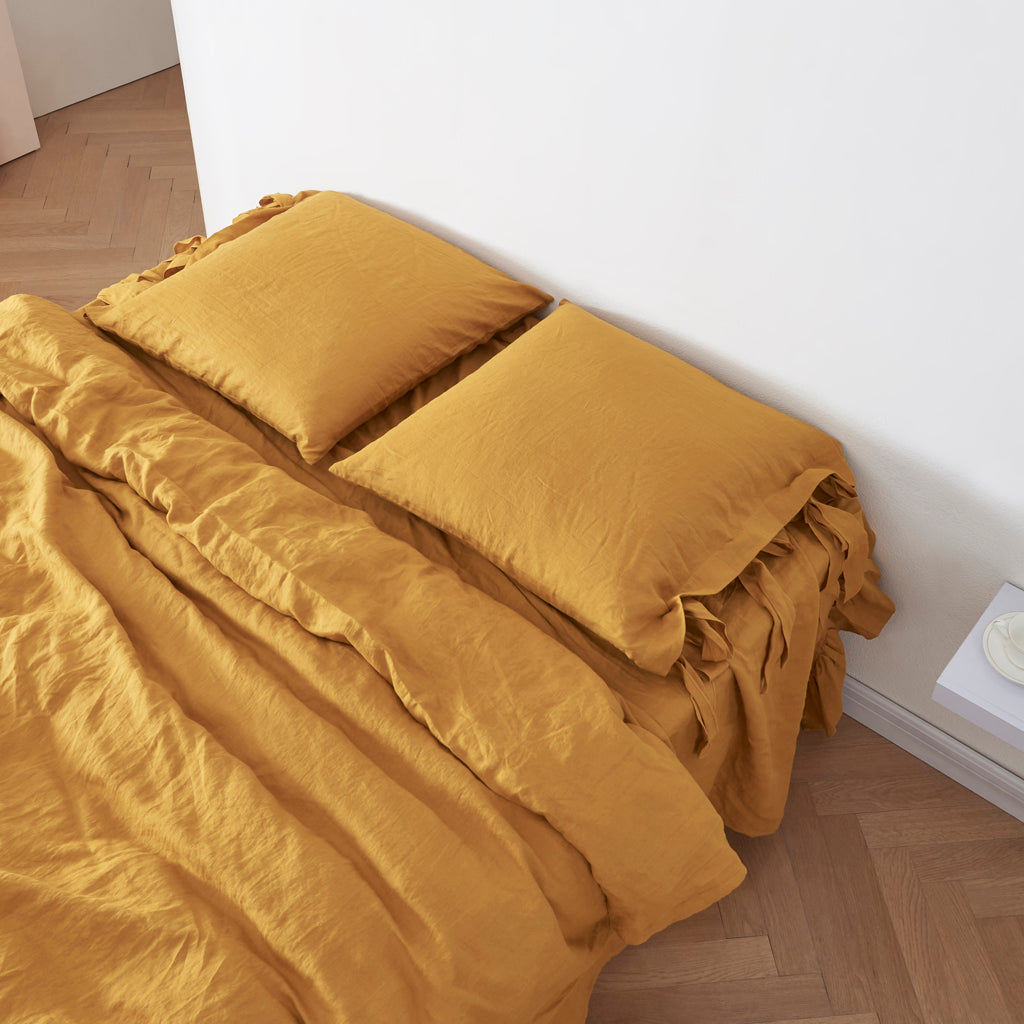 100% Linen Euro Pillowcases with Bow Ties in Mustard Yellow on Bed