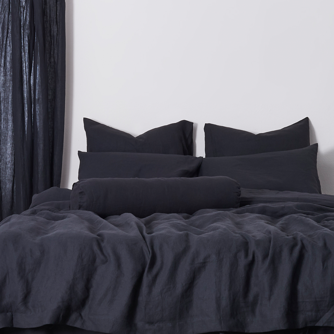 Buttoned 100% Linen Black Bolster Pillow on Bed