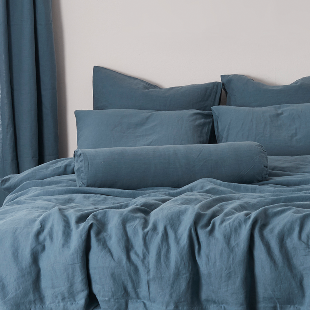 Buttoned Linen French Blue Bolster Pillow on Bed