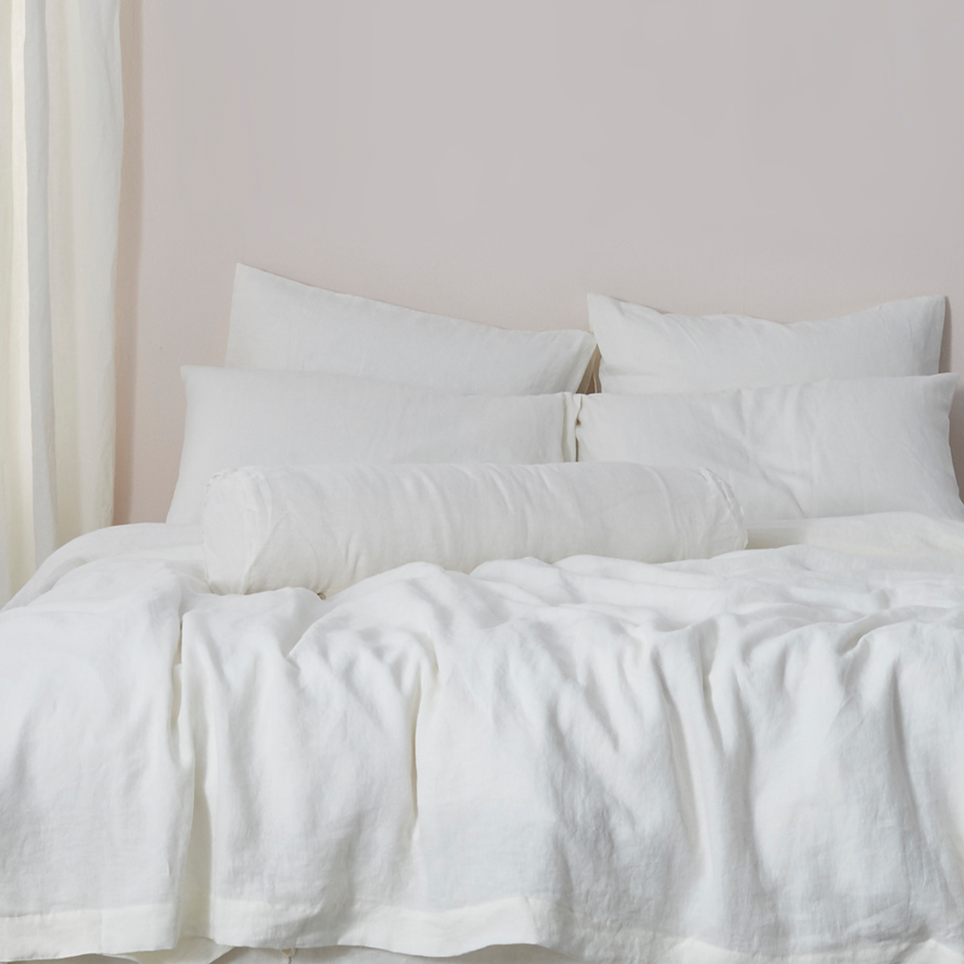 Ivory Buttoned Linen Bolster Cushion on Bed