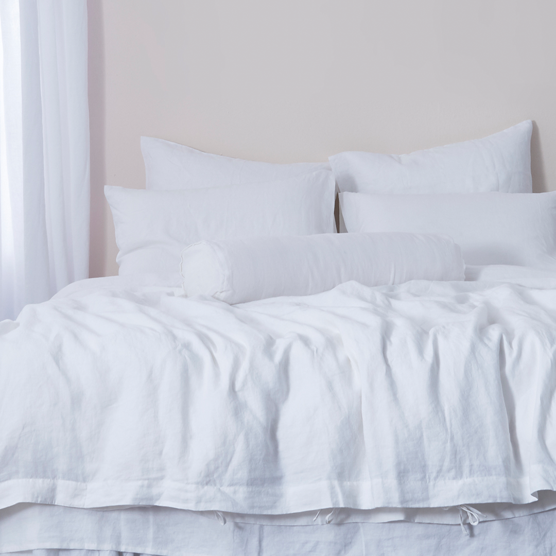 Optic White Buttoned Linen Bolster Cushion on Bed