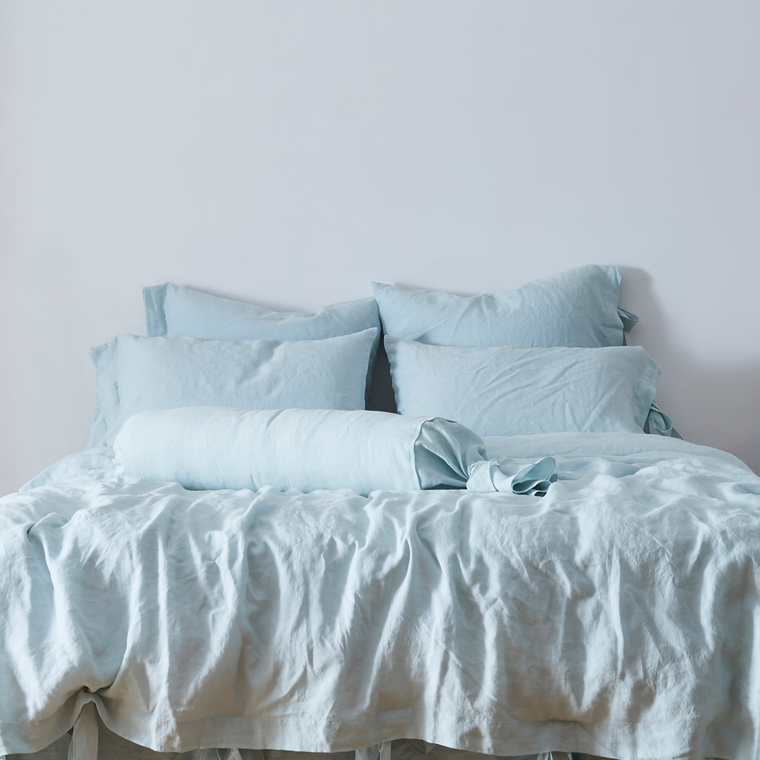 Pale Blue Linen Bow Ties Bolster Pillow on Bed