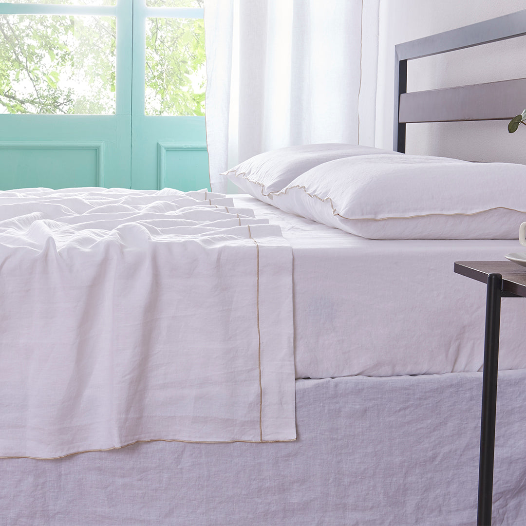 White Linen Flat Sheet with Embroidered Beige Edge on Bed