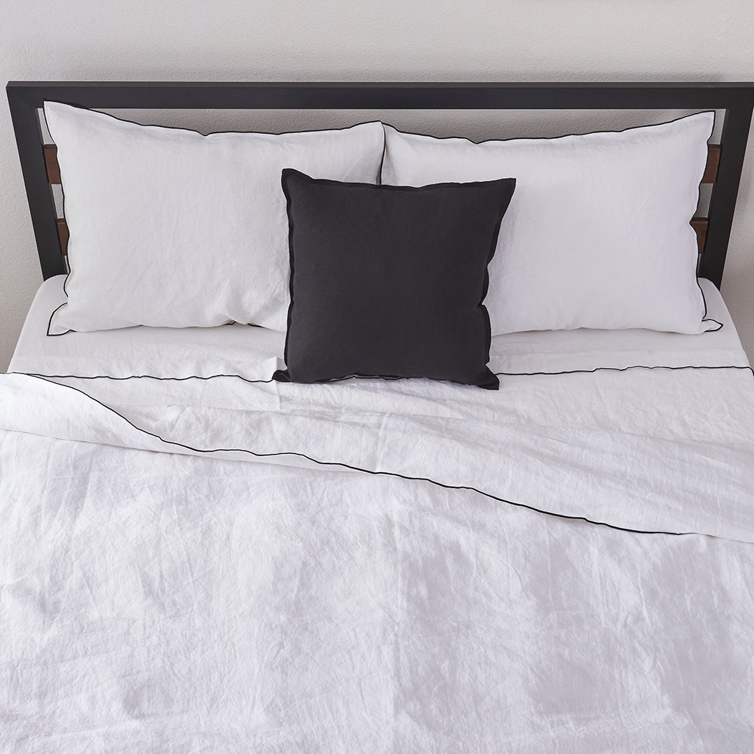 100% Linen White Duvet Cover with Black Embroidered Edge on Bed with Pillows