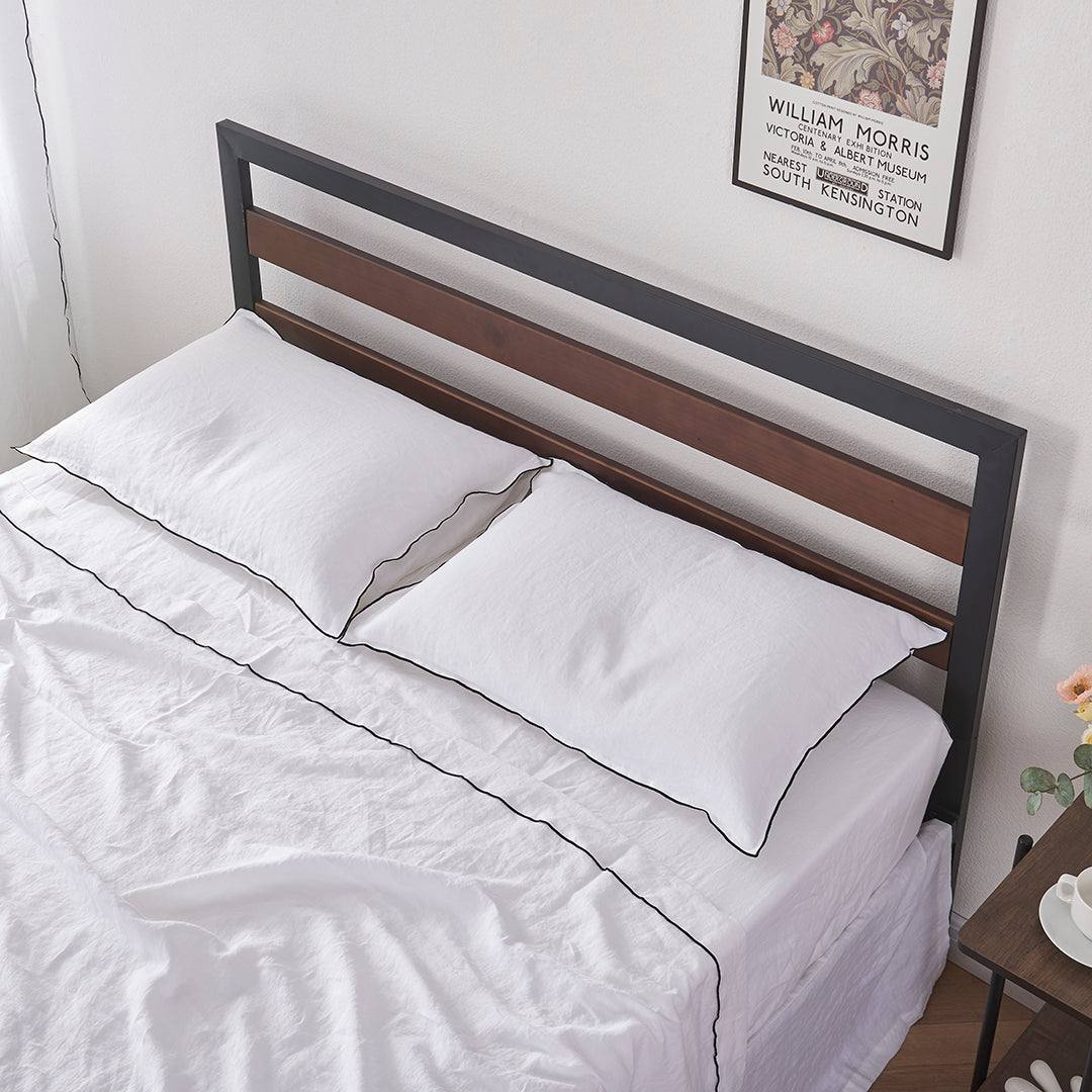 White Linen Pillowcases with Black Embroidered Edge on Bed