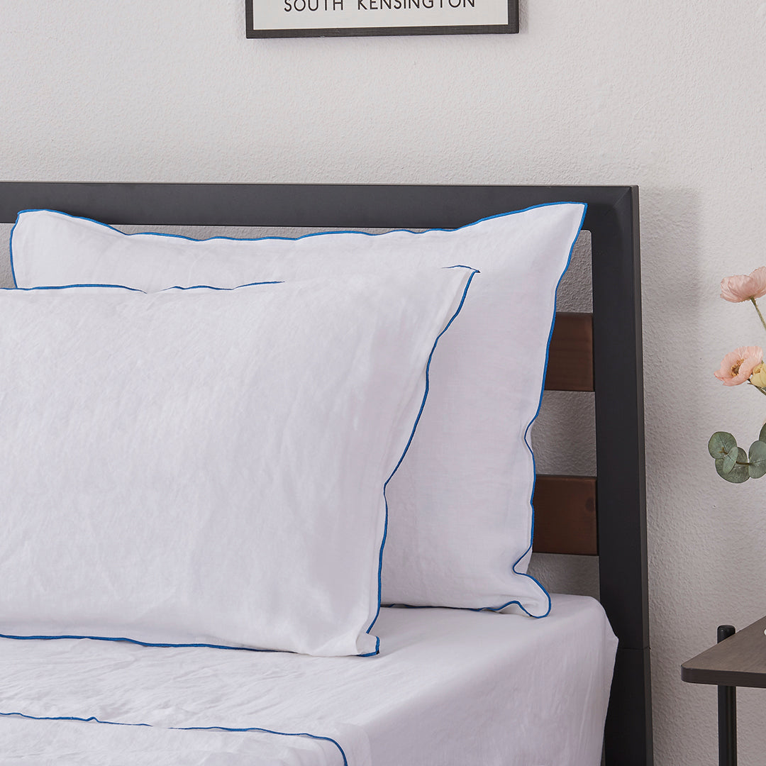 Brilliant Blue Embroidered Edge Detail on White Linen Pillowcases