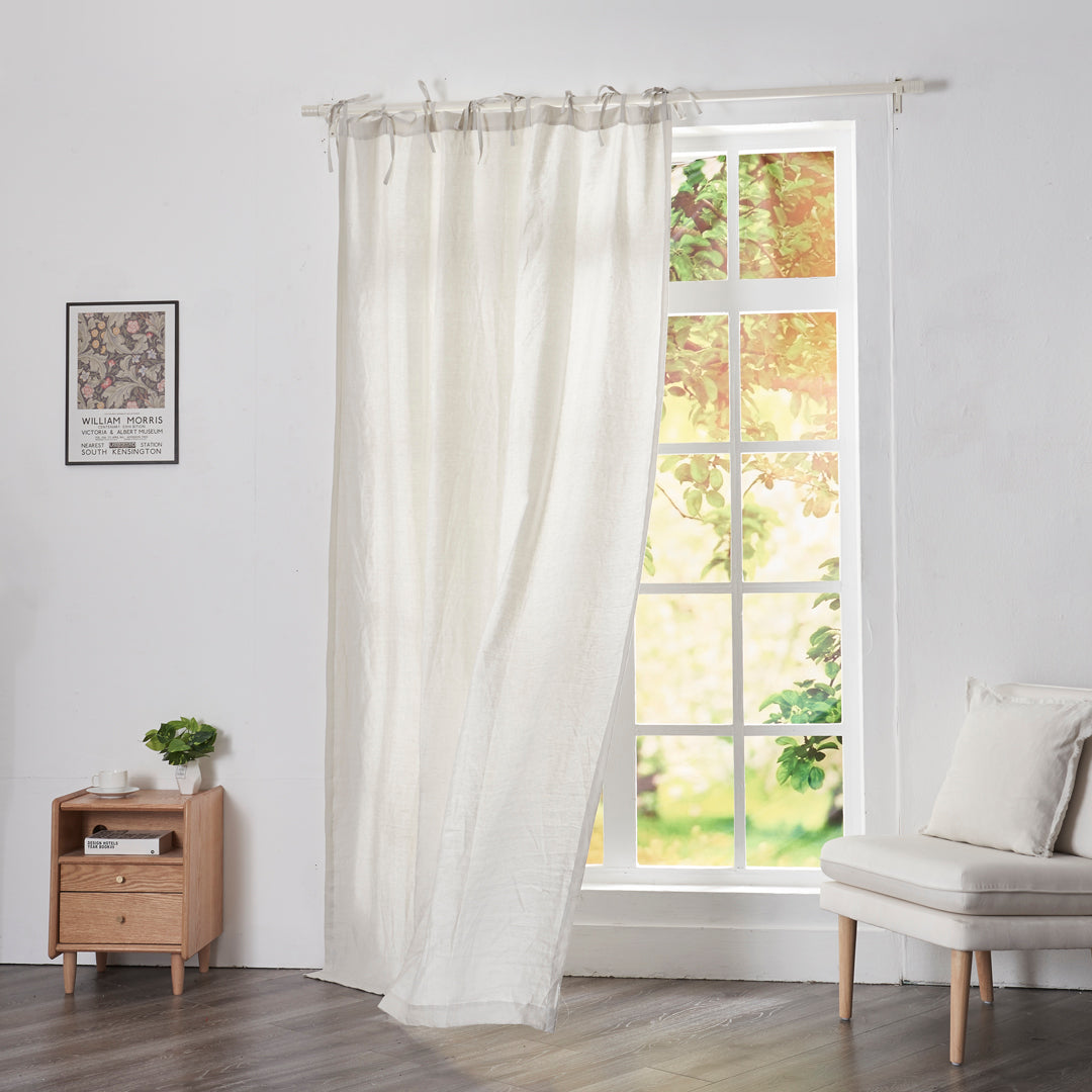 Cool gray linen curtain with tie tops on window