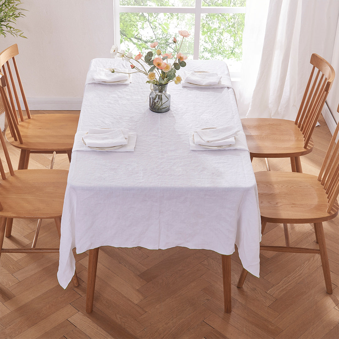 White Linen Tablecloth with Green Edge Embroidery on Dining Table