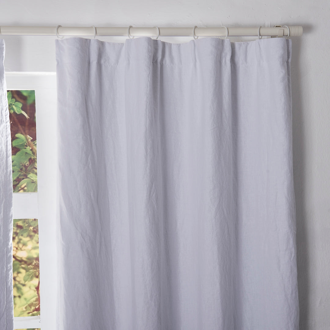 Close-up of the top of optic white linen drapery