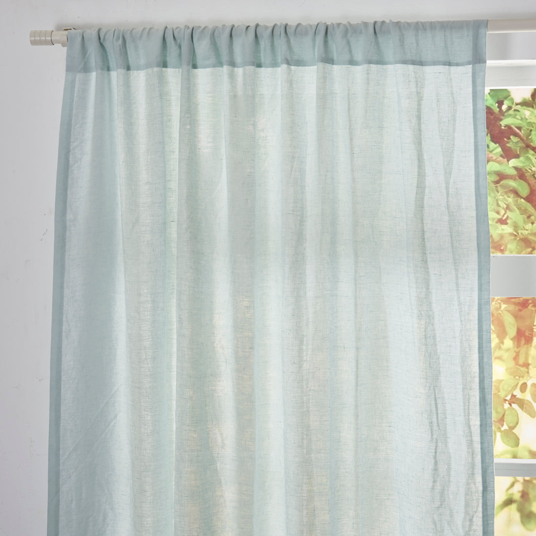 Close-up of the top of pale blue linen drapery