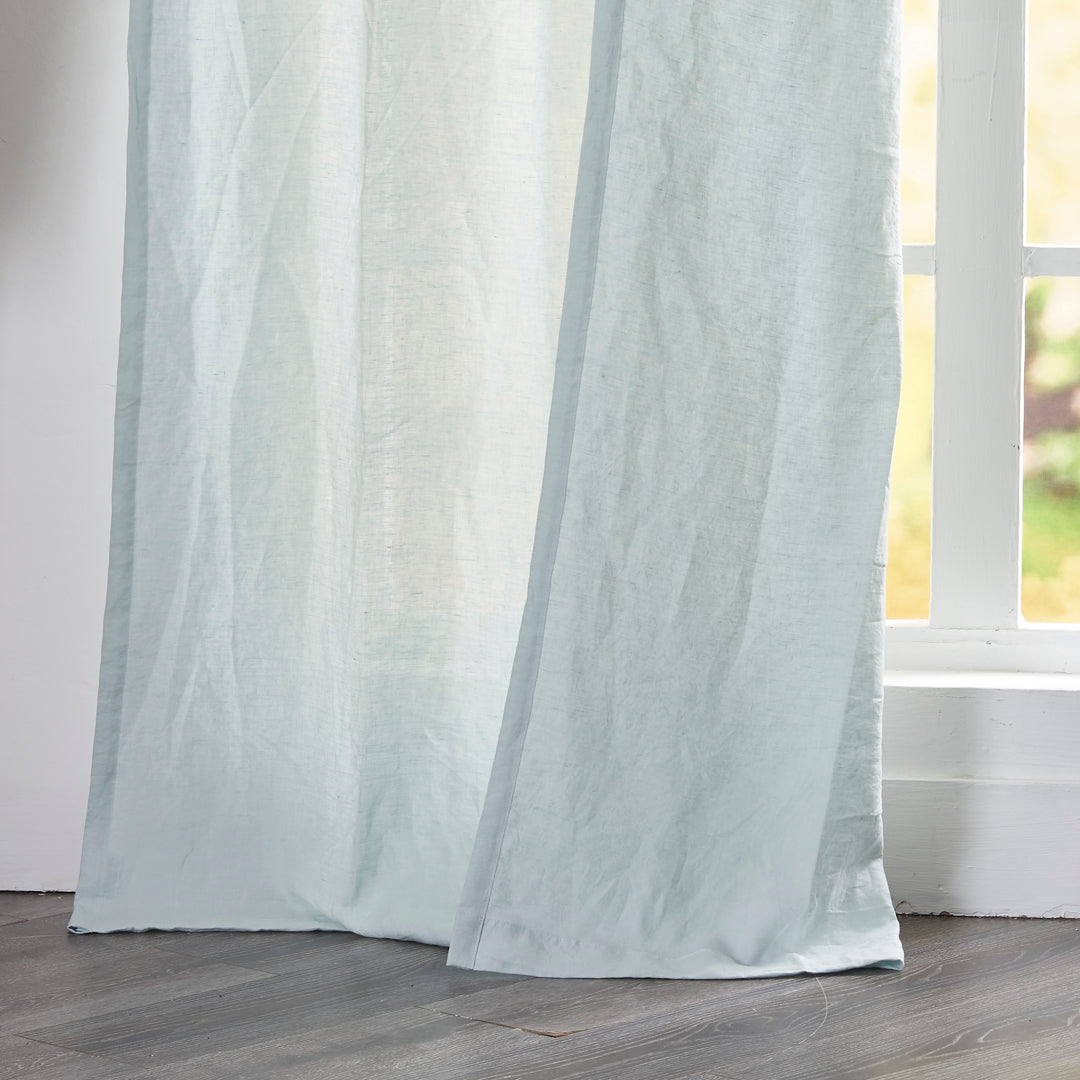 Close-up of 100% linen pale blue curtain hems