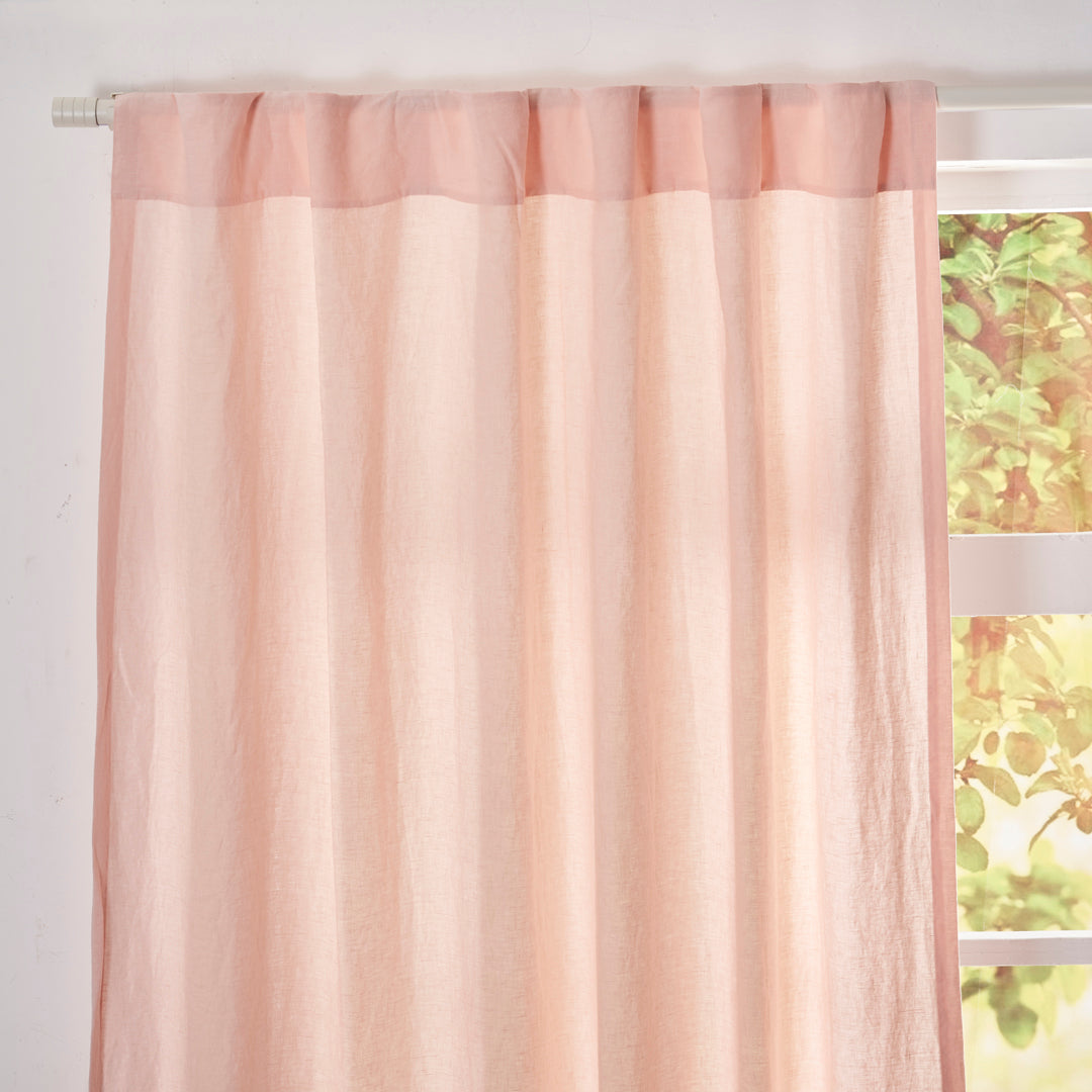 Close-up of the top of peach linen drapery