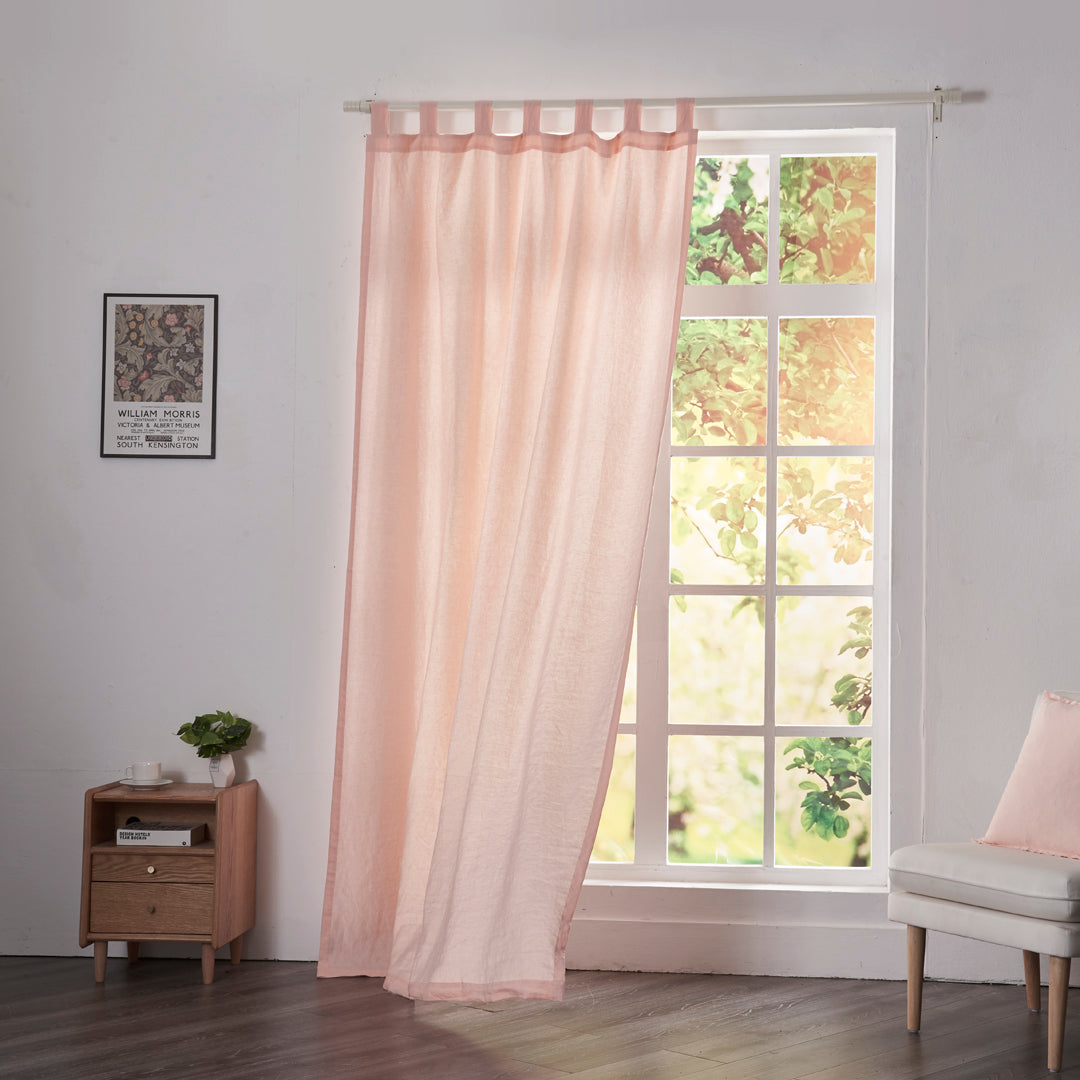Peach linen drapery with tab tops billowing over windows