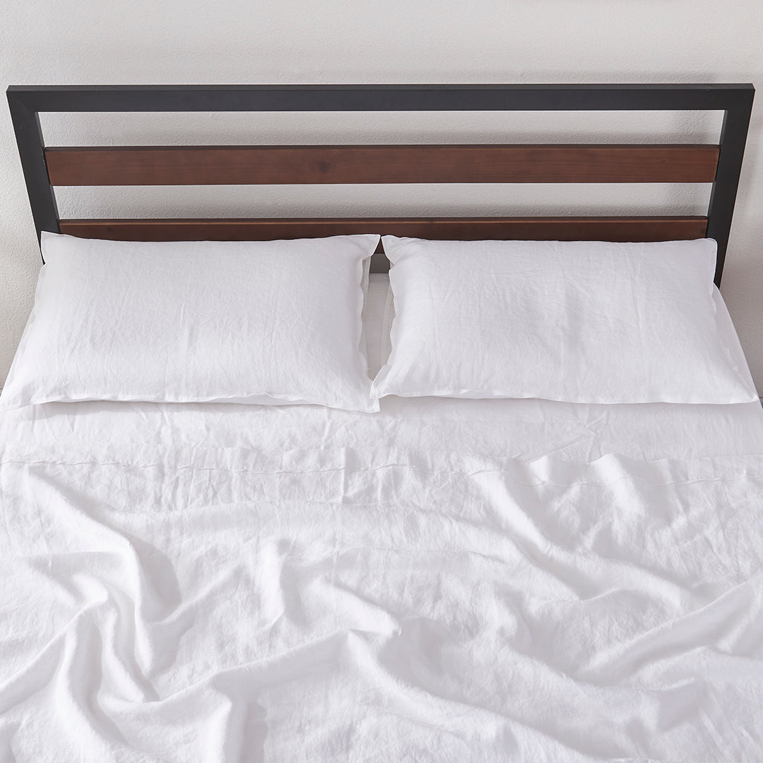 White Linen Flat Sheet with Embroidered Edge on Bed