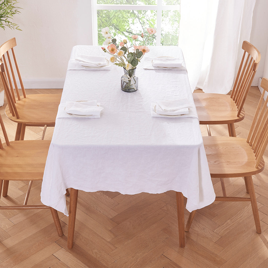 White Linen Tablecloth with Embroidered Edge on Dining Table