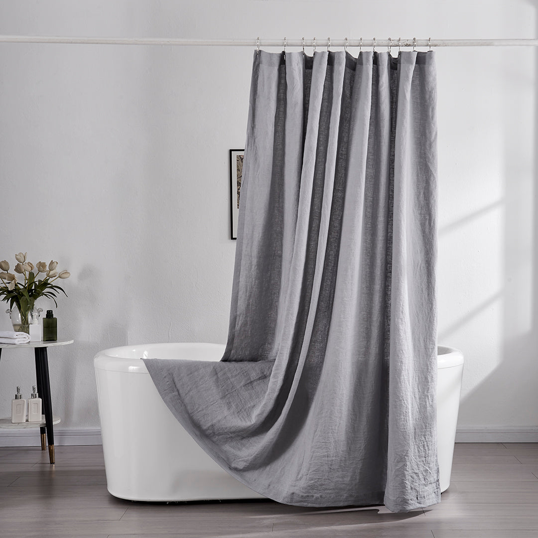 Gray Linen Shower Curtain Hanging in Bathroom with White Soaker Tub