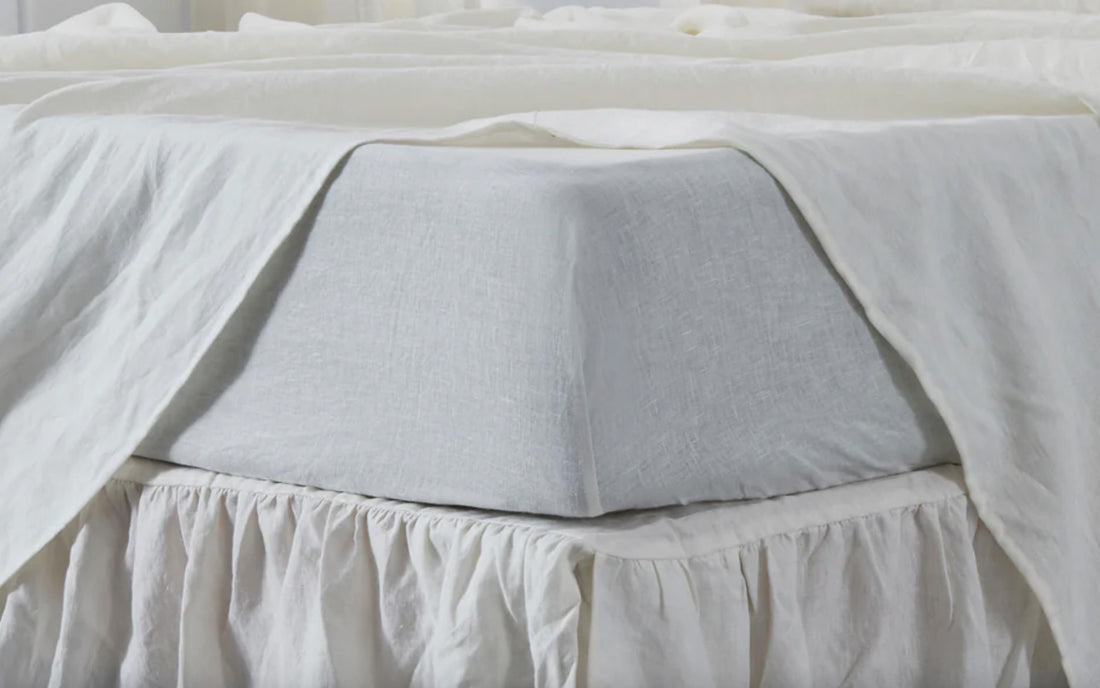 Ivory linen sheets on bed