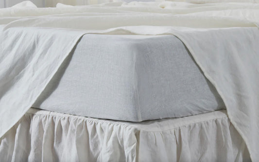 Ivory linen sheets on bed