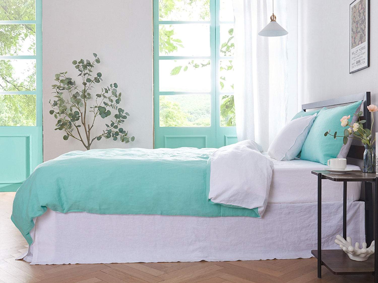 Two-toned aqua and white linen duvet cover on bed