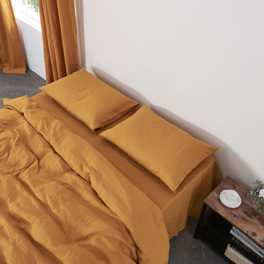 Mustard Yellow Linen Pillowcases on Bed