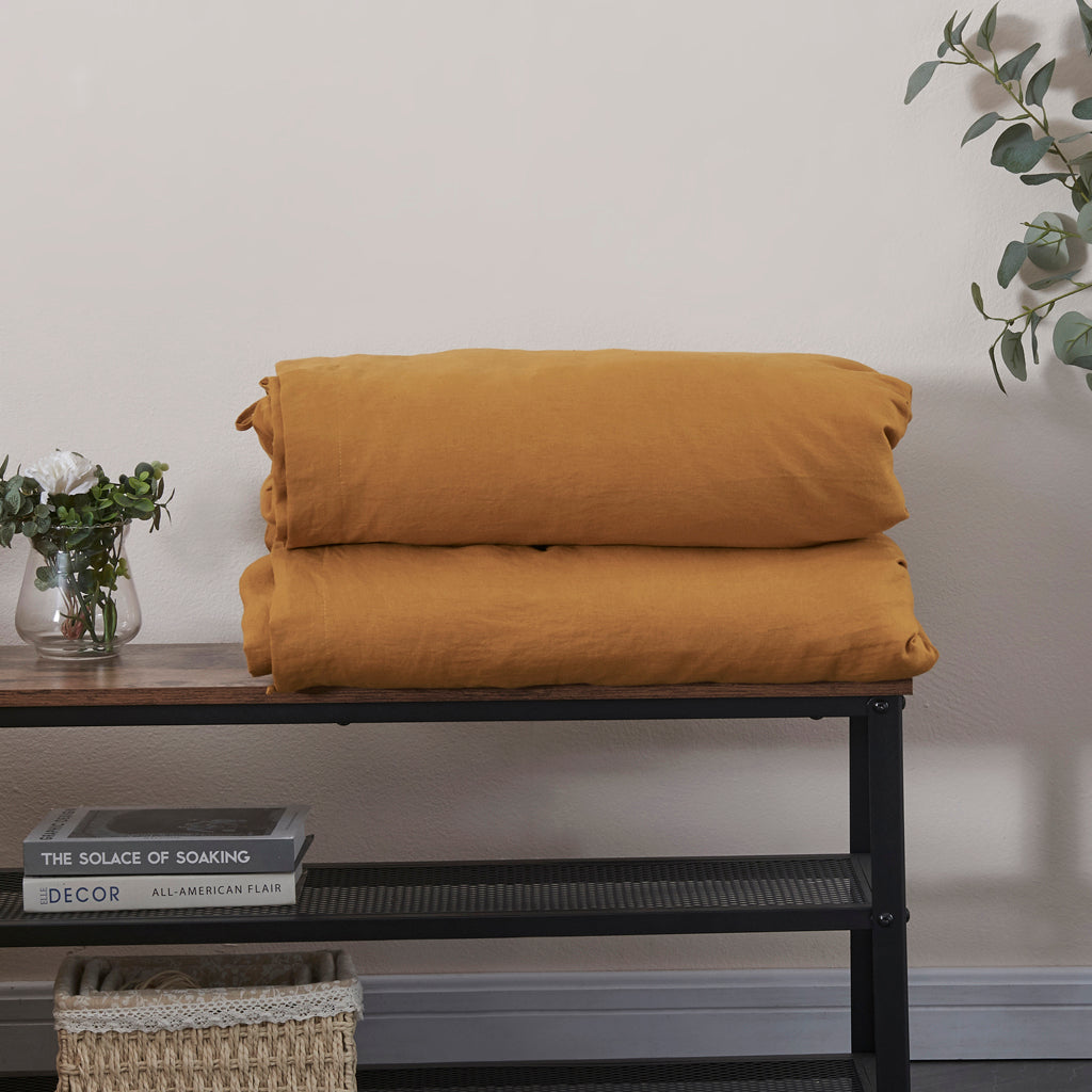 Folded Linen Duvet Cover in Mustard Yellow on Shelf