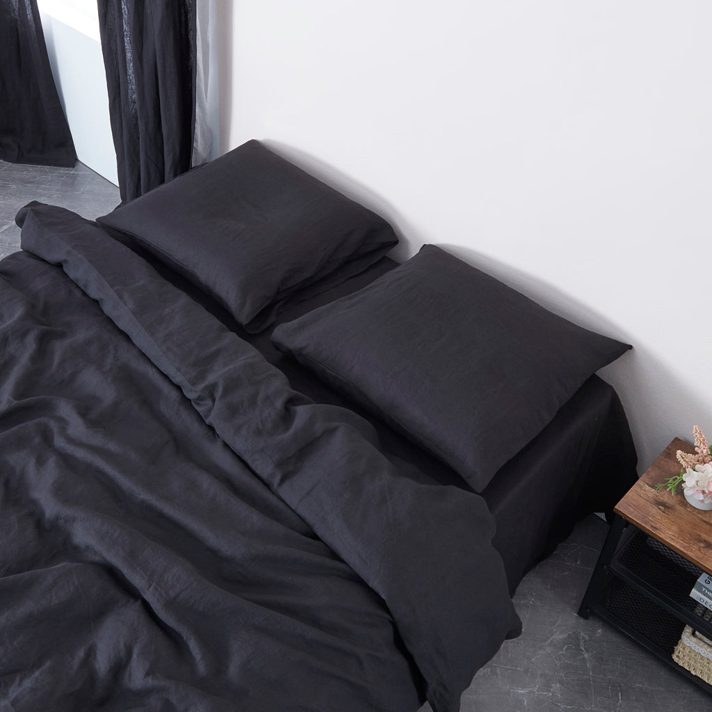 Pillows on Bed with Black Linen Pillowcases and Bedding