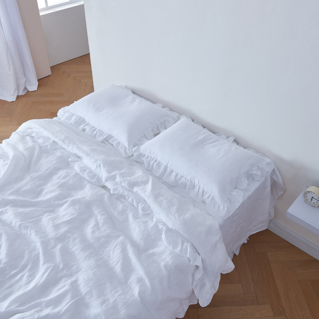 Optic White Linen Ruffle Hem Pillowcases on Bed
