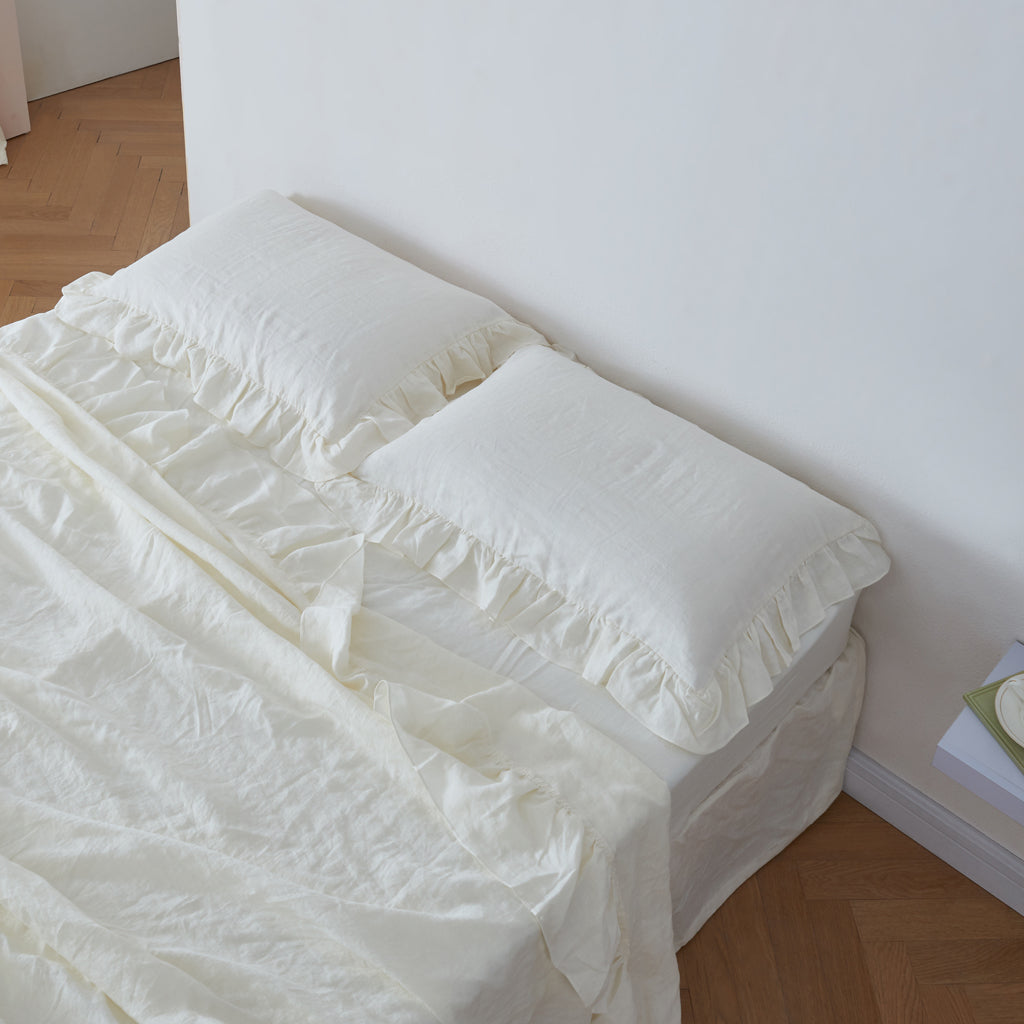 Ivory Linen Ruffle Pillowcases on Bed