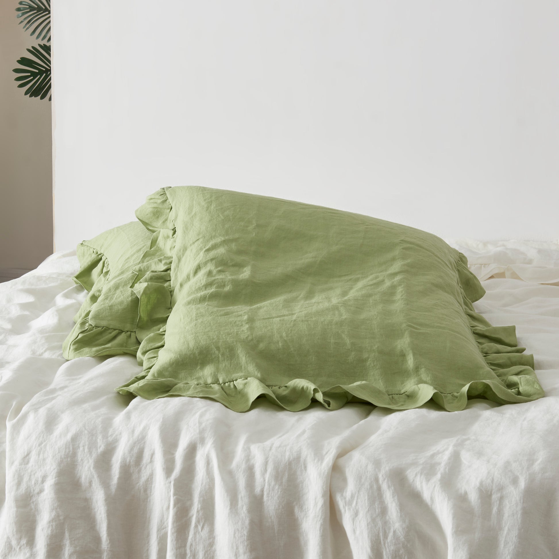 Matcha Green Square Linen Pillowcase Pair with Ruffle Hem on Bed