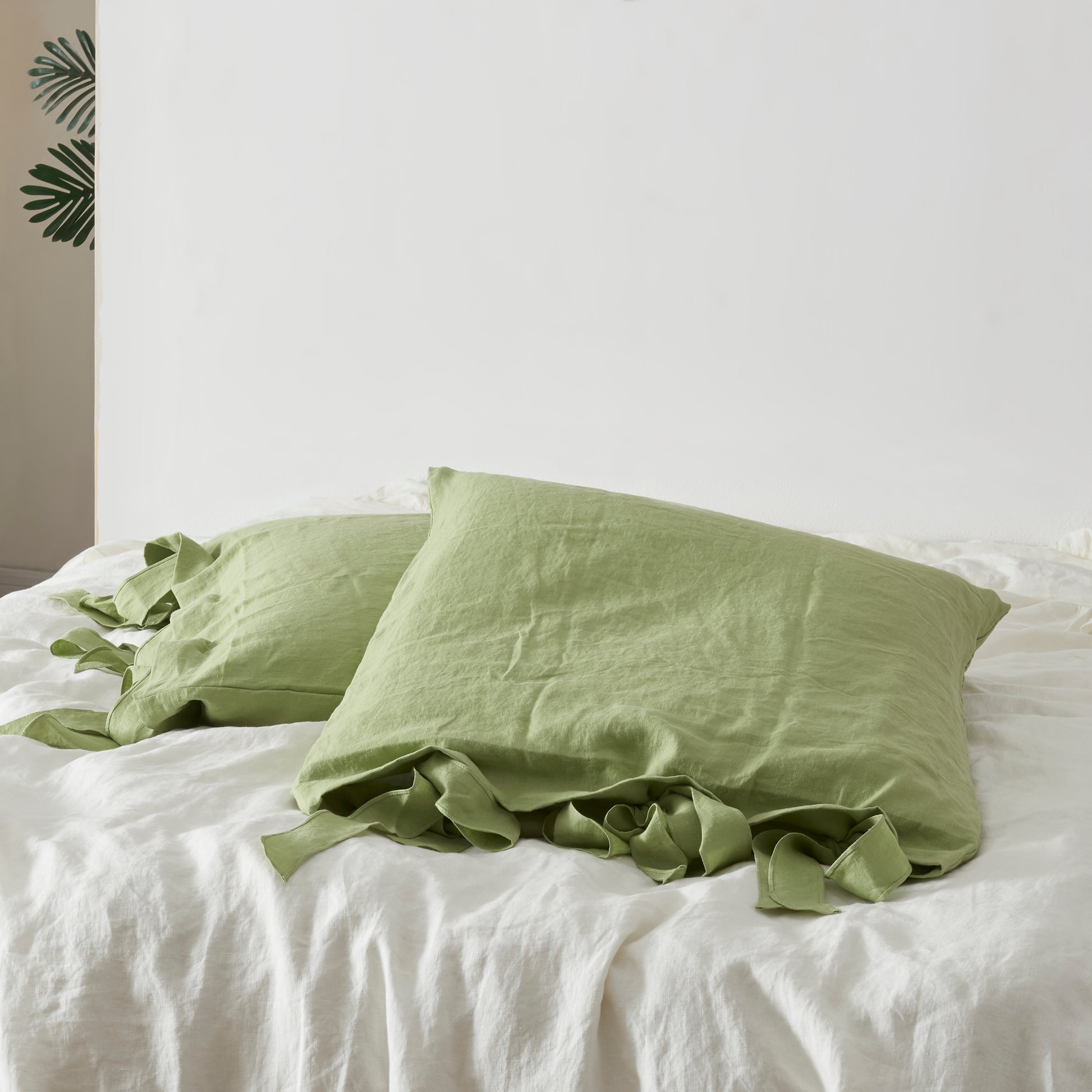 Matcha Green Bow Tie Linen Pillowcases on Bed