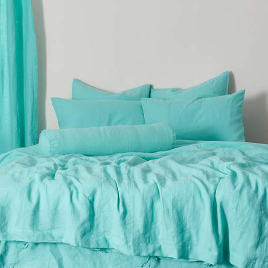 Aqua Green Buttoned Linen Bolster Cushion on Bed