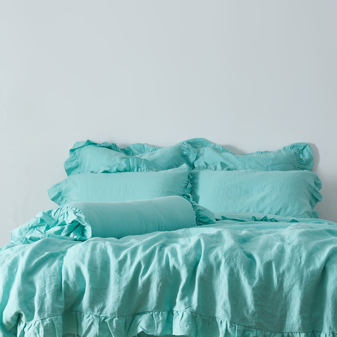 Aqua Green Linen Ruffle Hem Bolster Cushion on Bed