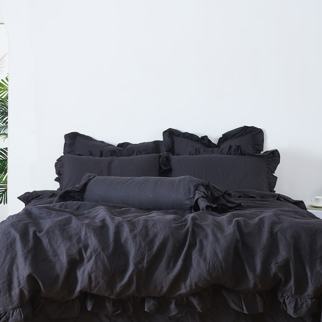 Black Linen Ruffle Bolster Cushion on Bed