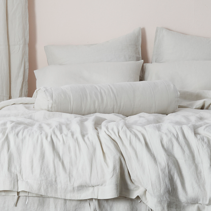 Buttoned Cool Gray Linen Bolster Pillow on Bed