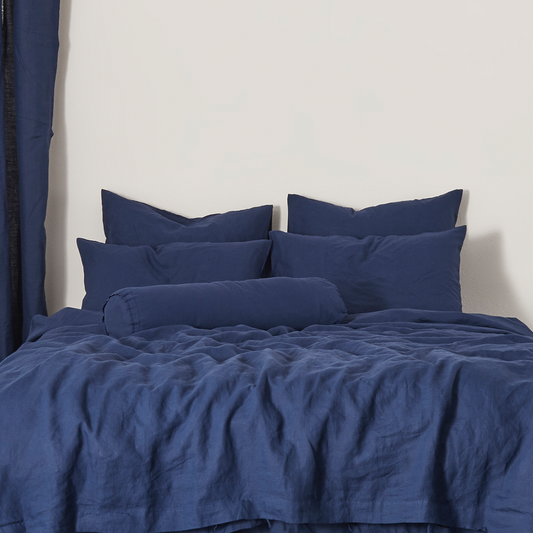 Indigo Blue Buttoned Linen Bolster Cushion on Bed