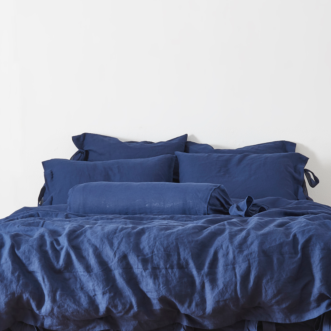 Indigo Blue Linen Bow Ties Bolster Pillow on Bed