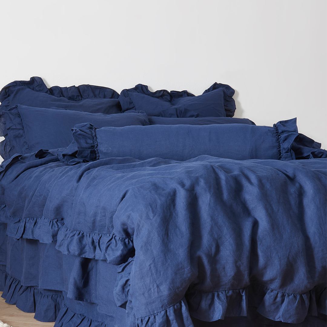 Indigo Blue Linen Ruffle Hem Bolster Cushion on Bed