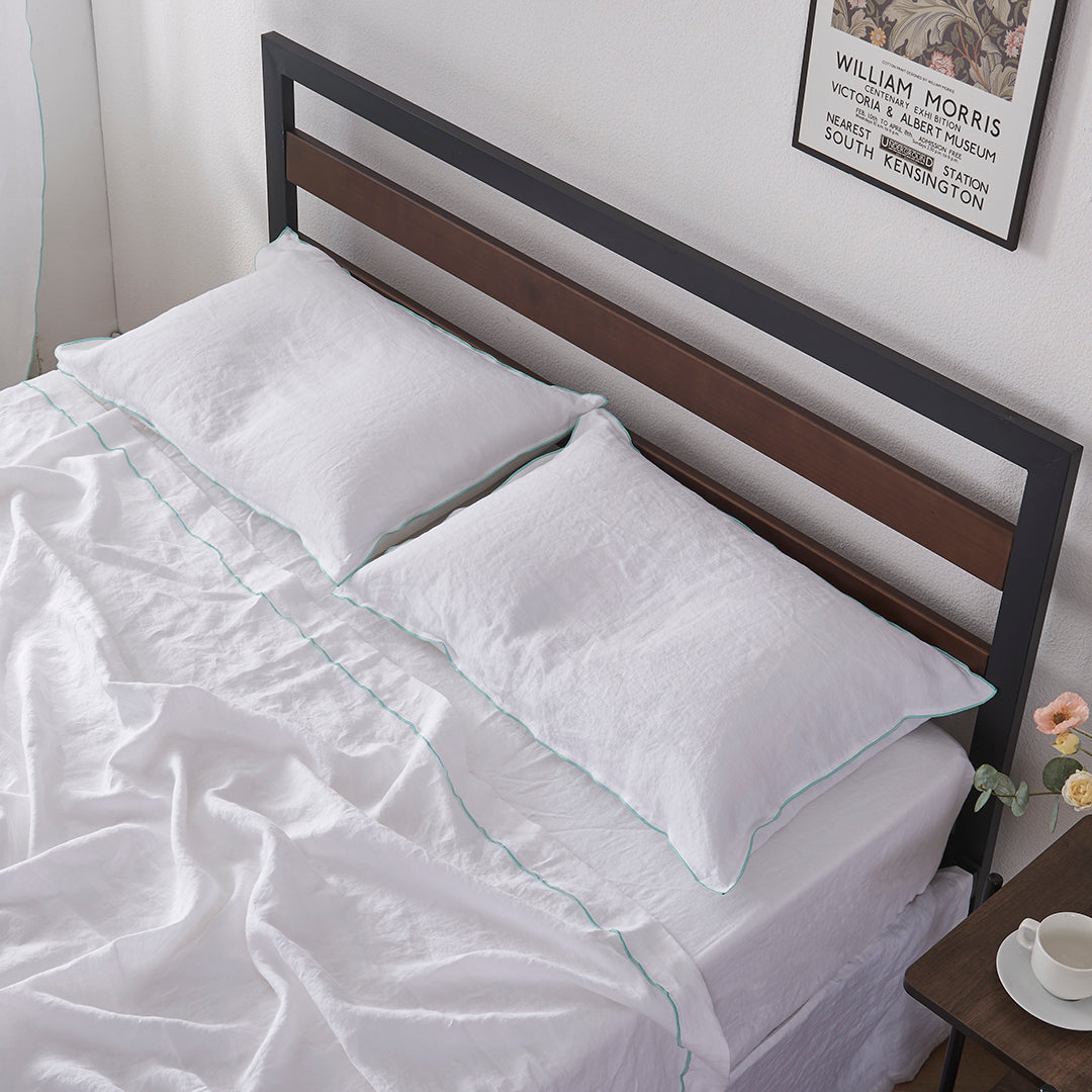 Aqua Edge Embroidery Linen Pillowcases on Bed