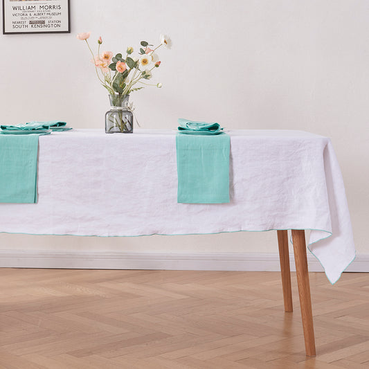 White Linen Tablecloth with Embroidered Aqua Green Edge on Table