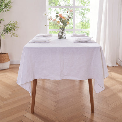 White Linen Tablecloth with Beige Embroidered Edge on Dining Table