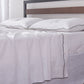 Bed with 100% Linen White Flat Sheet with Black Embroidered Edge and Pillows