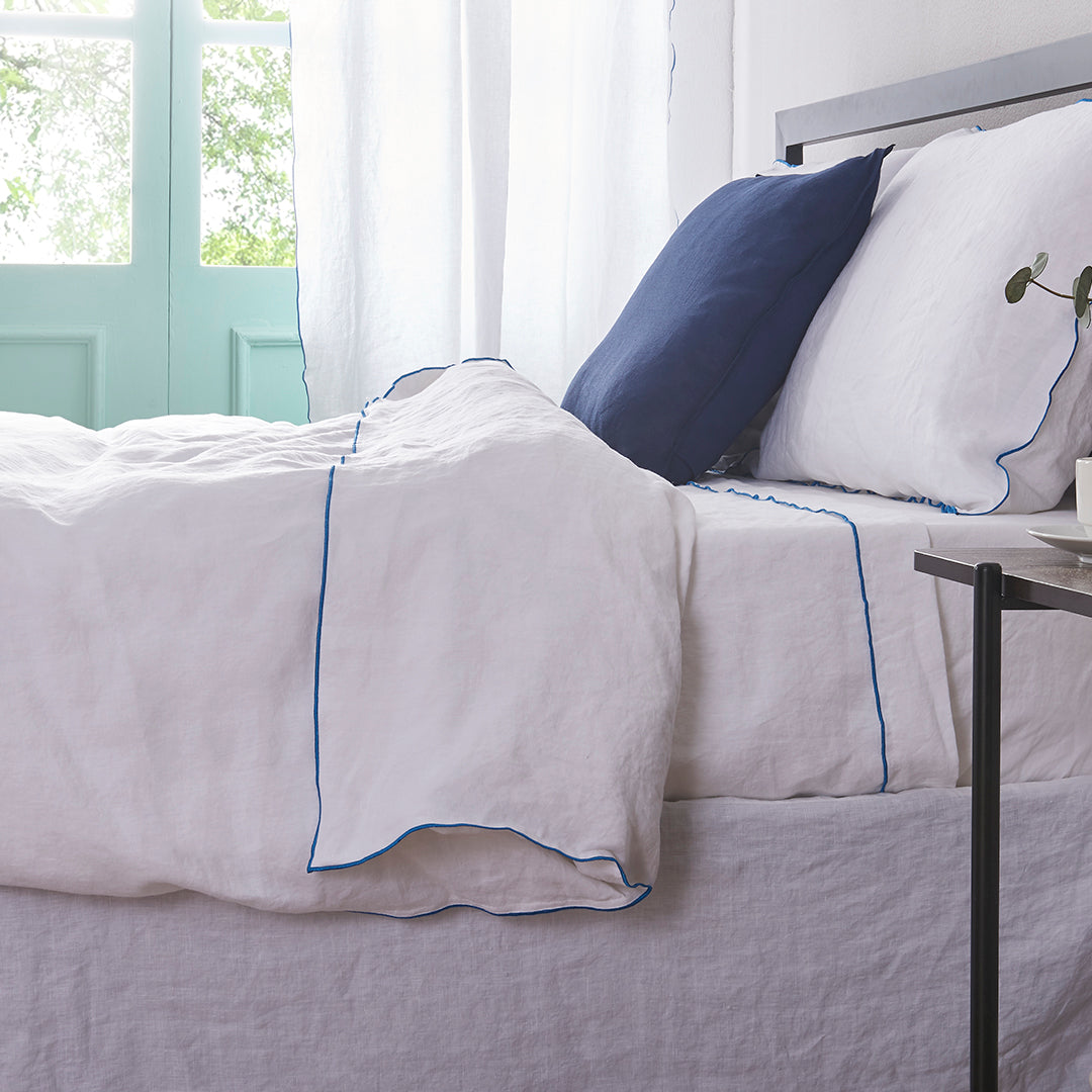 Brilliant Blue Edge Embroidered White Linen Duvet Cover on Bed