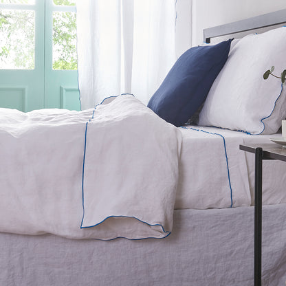 Brilliant Blue Edge Embroidered White Linen Duvet Cover on Bed