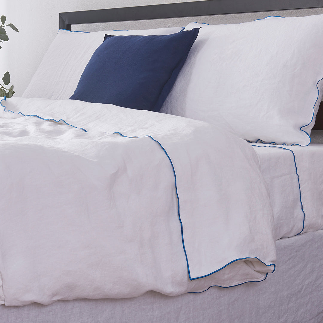 Brilliant Blue Edge Embroidered White Linen Duvet Cover and Pillowcases on Bed