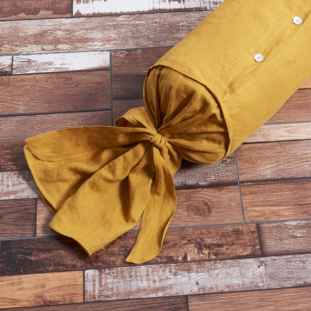Close up details on 100% linen bow tie bolster with shell buttons in mustard