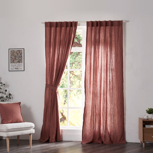 Rusk red linen drapery with cotton lining hanging over windows